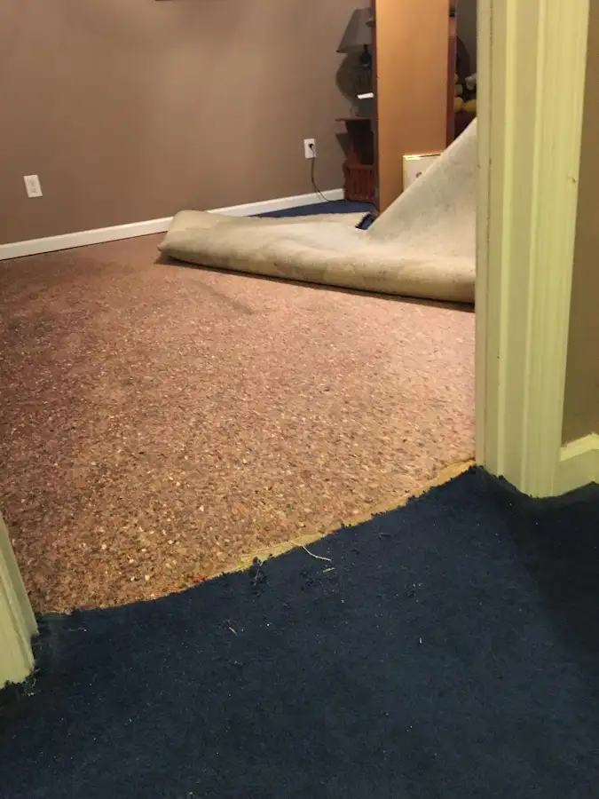 Carpet pad removal revealing water damage during Water Mitigation Services in Redding