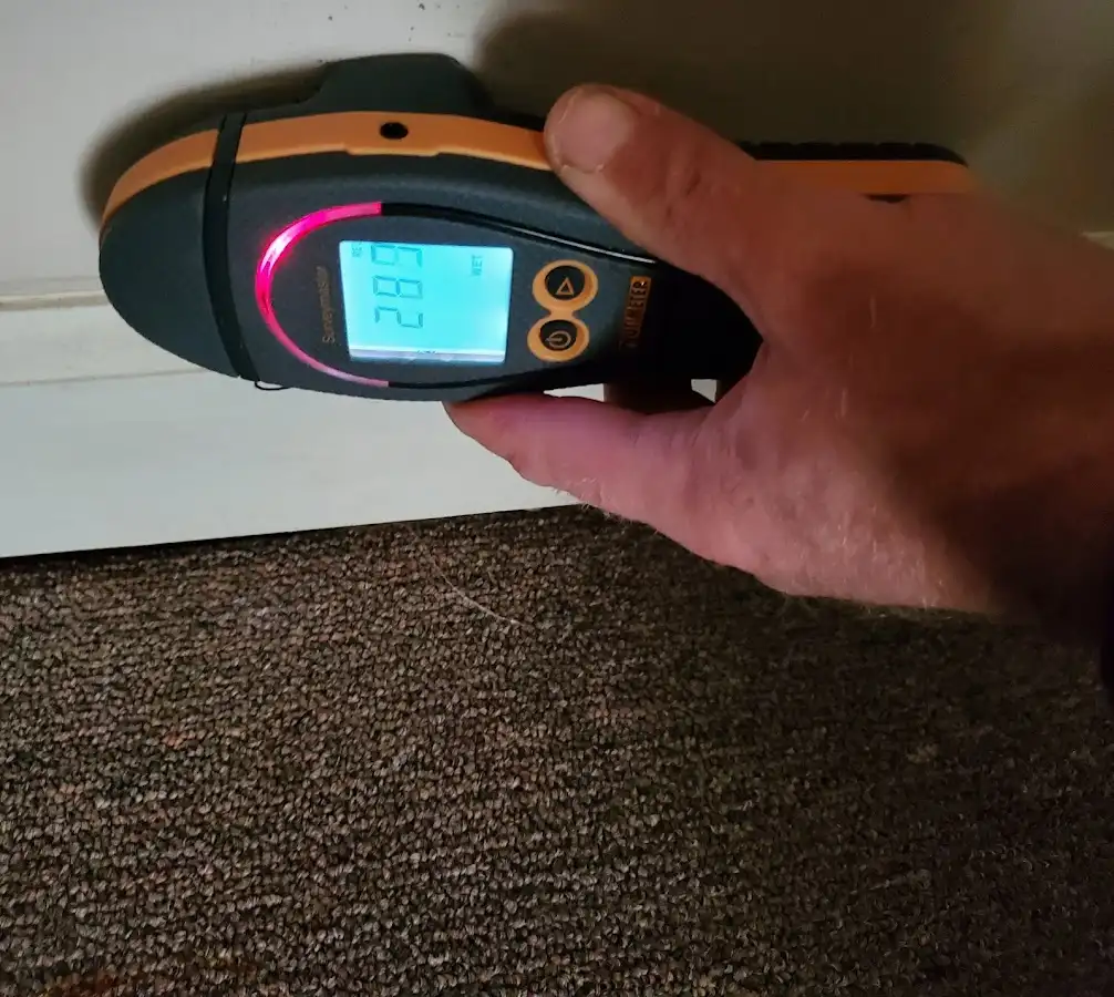 Moisture detection at baseboard during Storm Damage Restoration in Redding